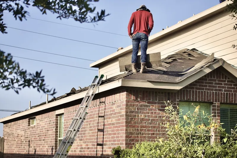 Professional roofer working on a residential roof in Carriage Square
